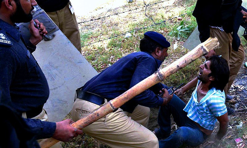 Policemen arrest a follower of Tahirul Qadri during a protest in Lahore on June 17, 2014.— AFP/File photo