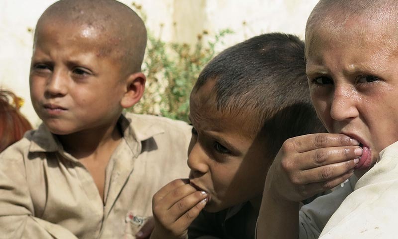 Children fleeing  North Waziristan, eat their meal while taking refuge with their family in a school building in Bannu, located in Pakistan's Khyber-Pakhtunkhwa province. — Photo by Reuters