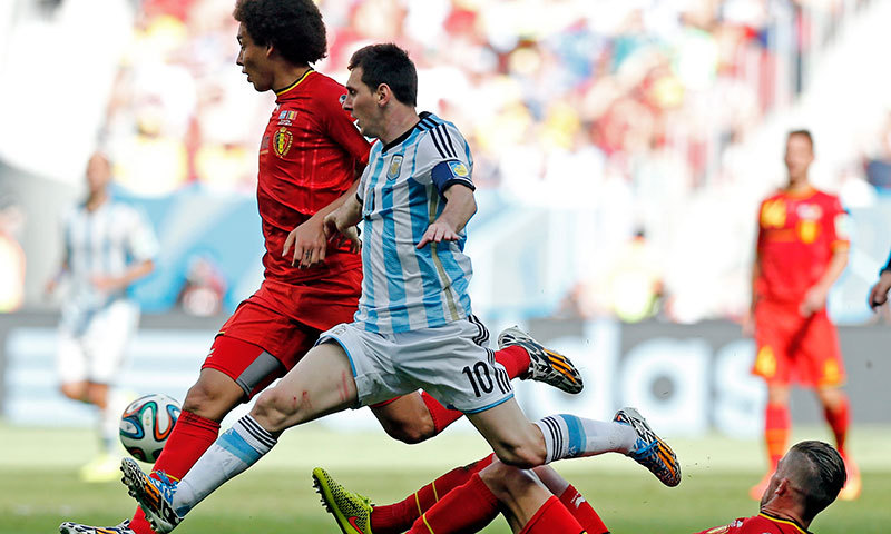 Argentina's Lionel Messi leaps in unison with Belgium's Axel Witsel as they chase the ball. – AP Photo