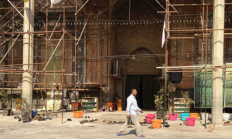 A man visits the Shiite holy al-Askari shrine in Samarra, 60 miles (95 kilometers) north of Baghdad, Iraq. -Photo by AP