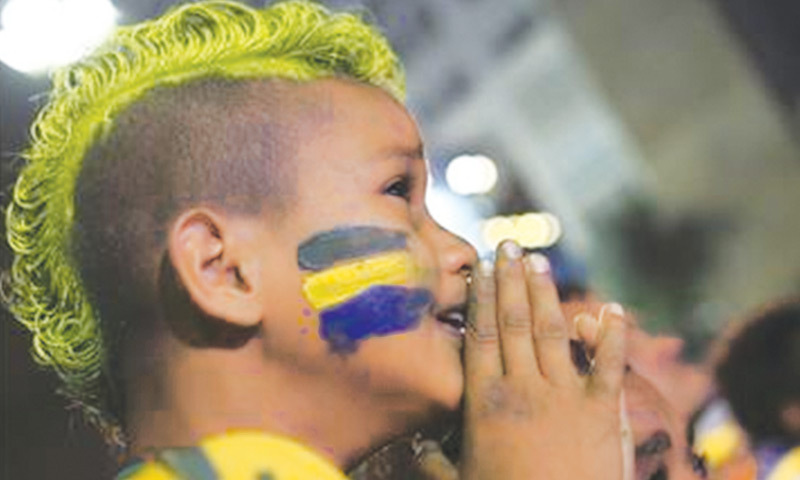A young Brazil fan reacts during the semi-final.—AP