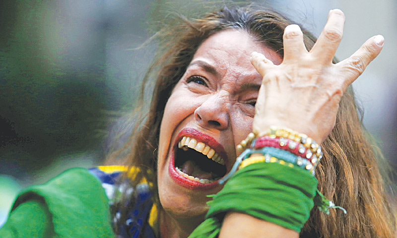 A Brazil fan cries as Germany score against her team.—AP