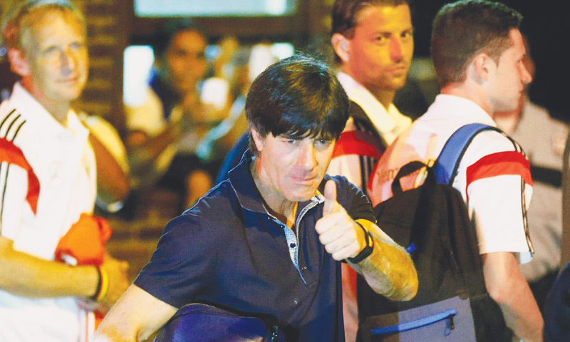 Germany’s coach Joachim Loew gives a thumbs-up before boarding a bus in the town of Santa Cruz Cabralia on Saturday.—Reuters