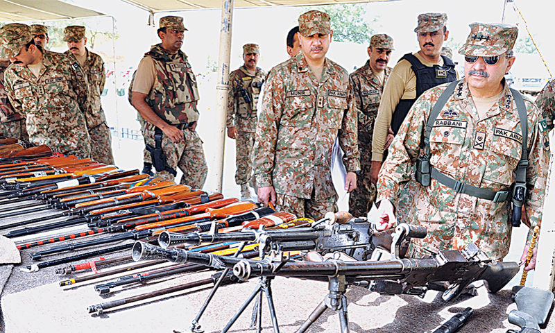 Mirali: Corps Commander Lt Gen Khalid Rabbani being briefed about the weapons seized from terrorists during the operation.—APP