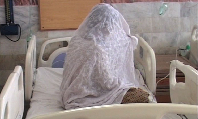 Noor Jehan, an acid attack survivor, hides her face while sharing details about the attack. -Photo by the writer