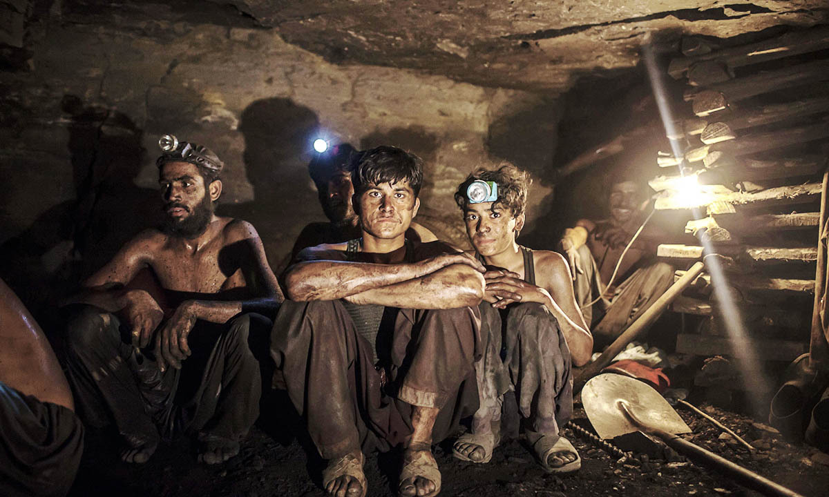 Miners pose for a photograph at the coal face inside a mine in Choa Saidan Shah, Punjab province, April 29, 2014. — Photo by Reuters