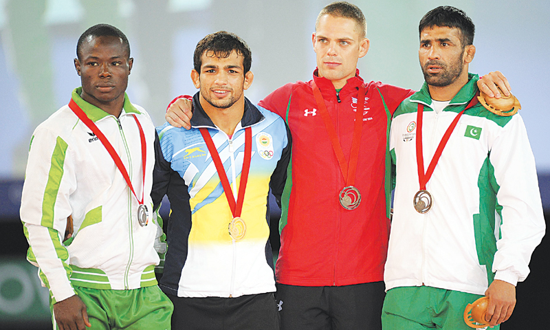 MEDALLISTS (L-R) Nigeria’s Ebikweminomo Welson (silver), India’s Amit Kumar Amit (gold), Wales’ Caig Pilling (bronze) and Pakistan’s Azhar Hussain (bronze) pose with their medals.—AFP