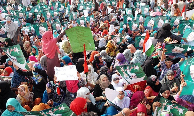 Activists of Pakistan Awami Tahreek hold a sit in demonstration outside Benazir Airport as they wait for arrival of Dr Tahirul Qadri. — Photo by Online