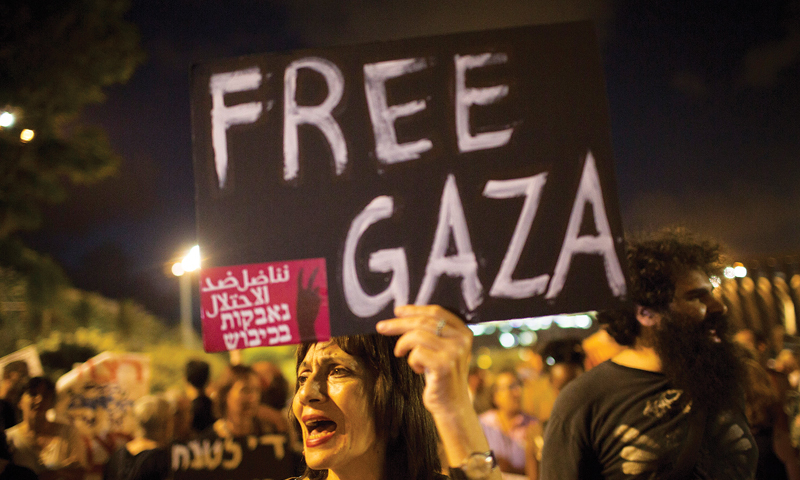 Israeli left wing activists take part in a protest against the attack on Gaza, in Rabin square in Tel Aviv. &mdash; Photo by Oren Ziv/ActiveStills