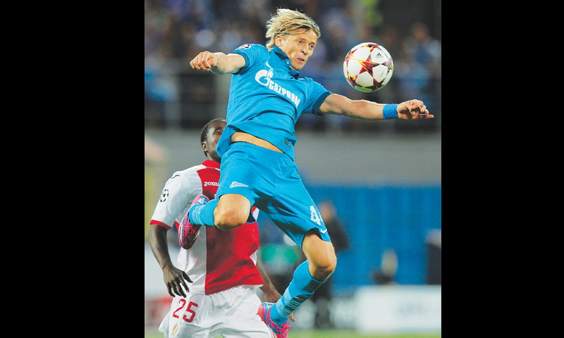 St. Petersburg: Zenit’s Anatoliy Tymoshchuk (above) fights for the ball with Standard de Liege’s Jeff Louis during their Champions League play-off.—AP