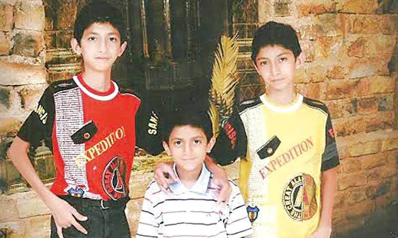 Three’s company: Hasham with his twin older brothers