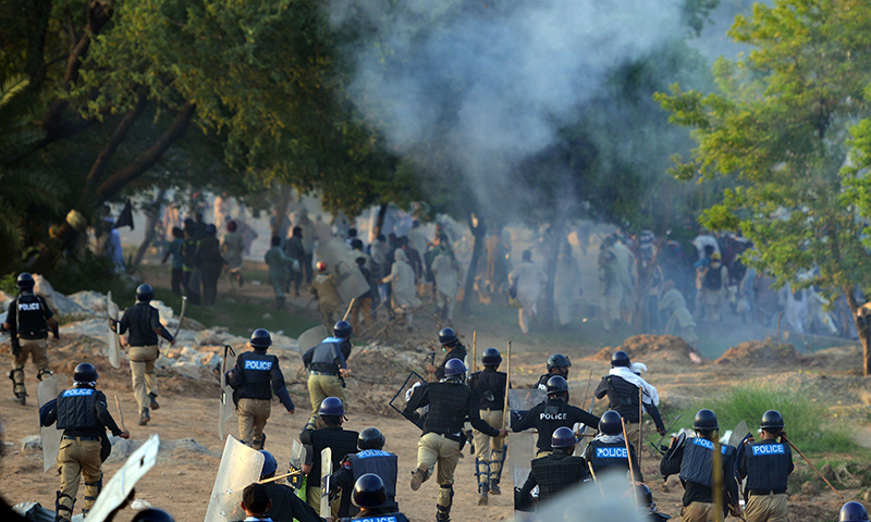 Pakistani riot police run towards supporters of Imran Khan and Tahirul Qadri during clashes near the prime minister's residence in Islamabad on August 31, 2014. — AFP photo