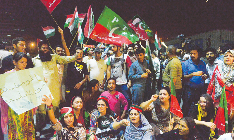 Lahore: Pakistan Tehreek-i-Insaf supporters hold a protest sit-in in Model Town here on Sunday against police action in Islamabad.&mdash;White Star