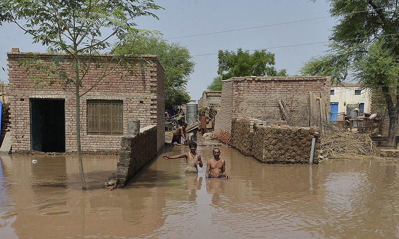 Residents affected by flooding gather outside their houses as they wait for help in Sher Shah, a town in Multan District. -Photo by AFP