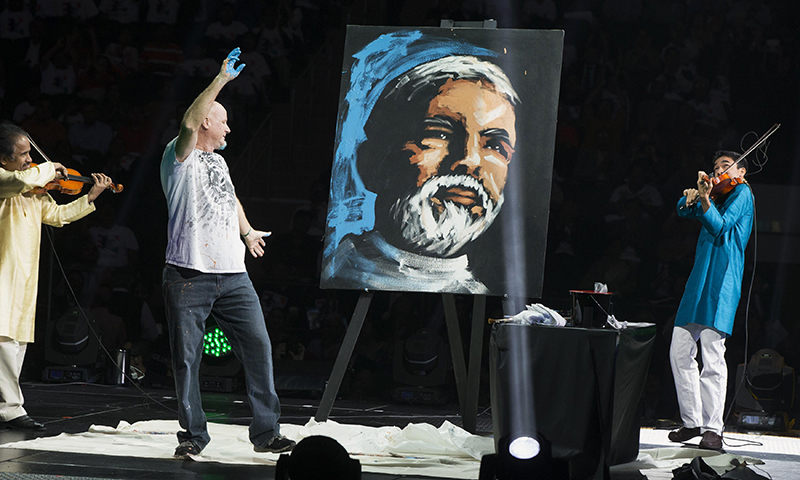  A painter reacts as he creates a portrait of India