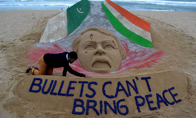 Indian sand artist Sudarsan Pattnaik gives the final touches to his sand sculpture at Puri beach on October 9, 2014. – AFP Photo