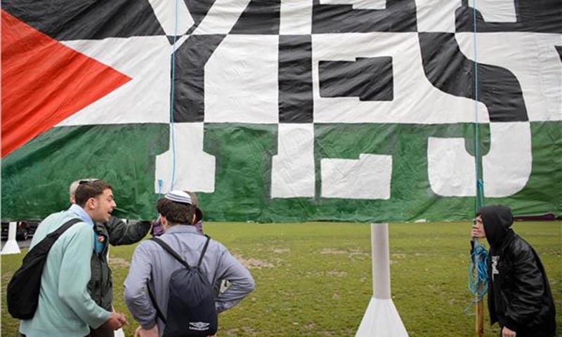 Young Jewish men argue with Pro-Palestinian supporters beside a giant banner calling for a recognised Palestinian State.— Photo by Reuters