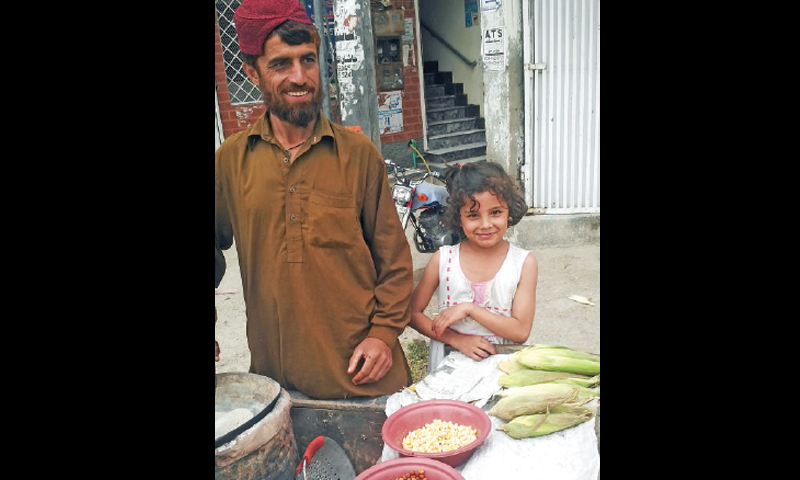 Khalida sells corn with her uncle.