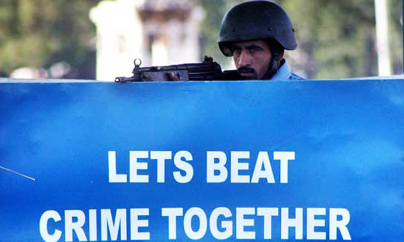 Police person stands alert in his check post in the federal capital.— File photo by Online