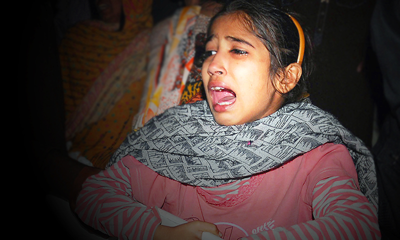 A child mourns blast victims at a hospital in Lahore after a suicide bomb attack near the Wagah border gate on November 2, 2014. — AFP