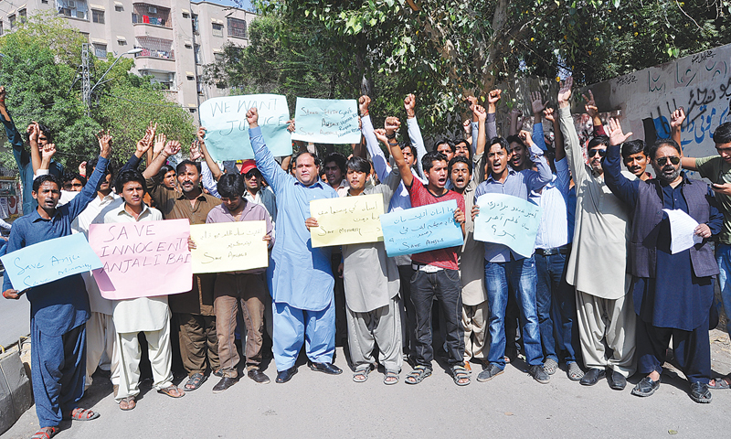 MEMBERS of the Hindu community protest outside the Hyderabad Press Club on Wednesday over alleged forced conversion and marriage of a Hindu girl in Daharki a few days ago.—Dawn