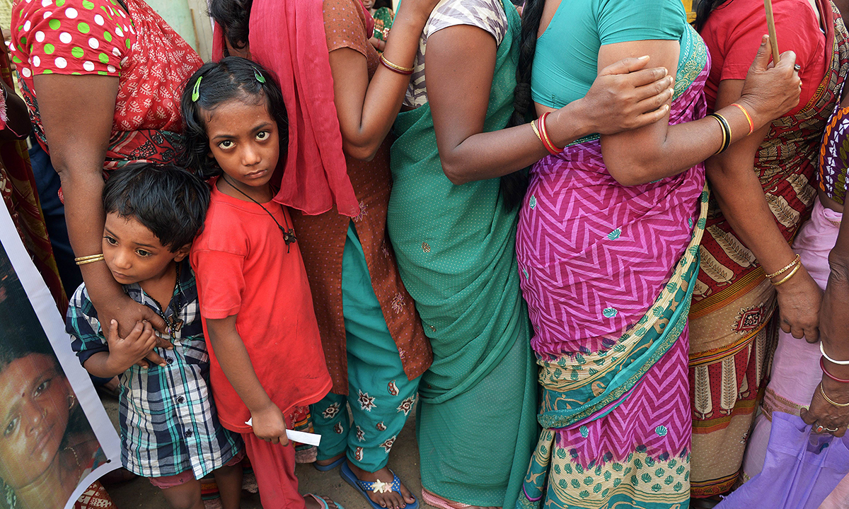 The children of Indian sex workers look on as they participate in the rally. — AFP Photo