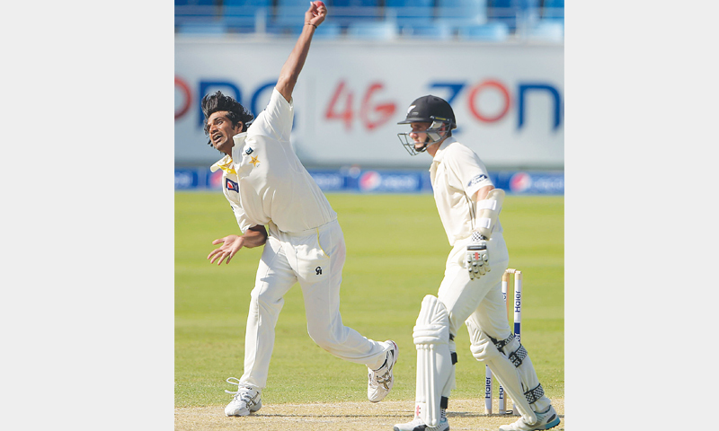 RAHAT Ali delivers the ball as Kane Williamson looks on.—AFP