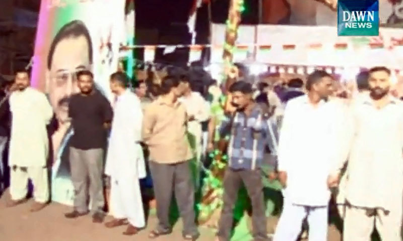 MQM activists stand outside the camp after the attack - DawnNews Screen grab