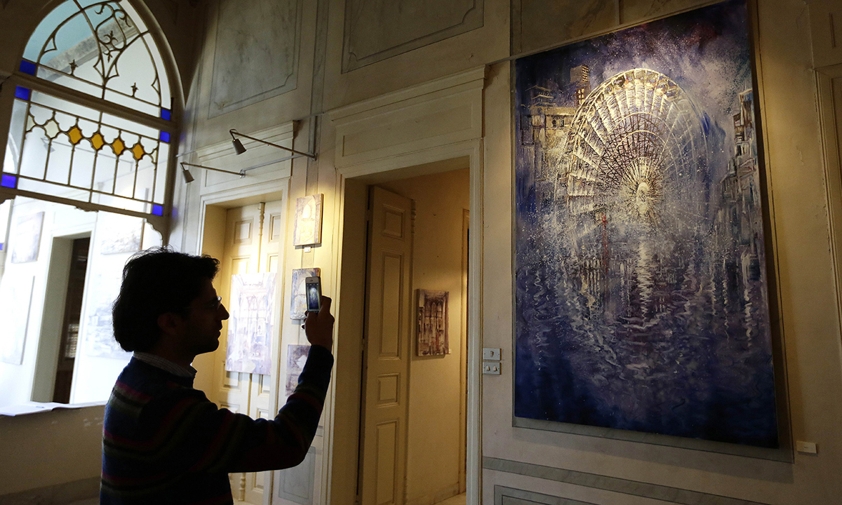A visitor looking at the exhibition. &mdash; AFP