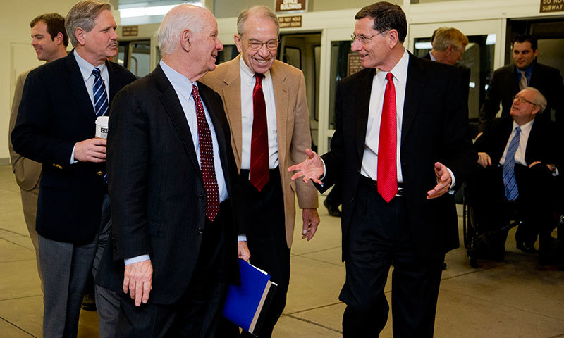 Senators John Hoeven, R-N.D, from left, Ben Cardin, D-Md, Chuck Grassley, R-Iowa, John Barrasso, R-Wyo, and Jay Rockefeller, D-W.Va., far back right, walk from the Senate subway on Capitol Hill in Washington, Friday, Dec. 12, 2014. &mdash; AP/Manuel Balce Ceneta