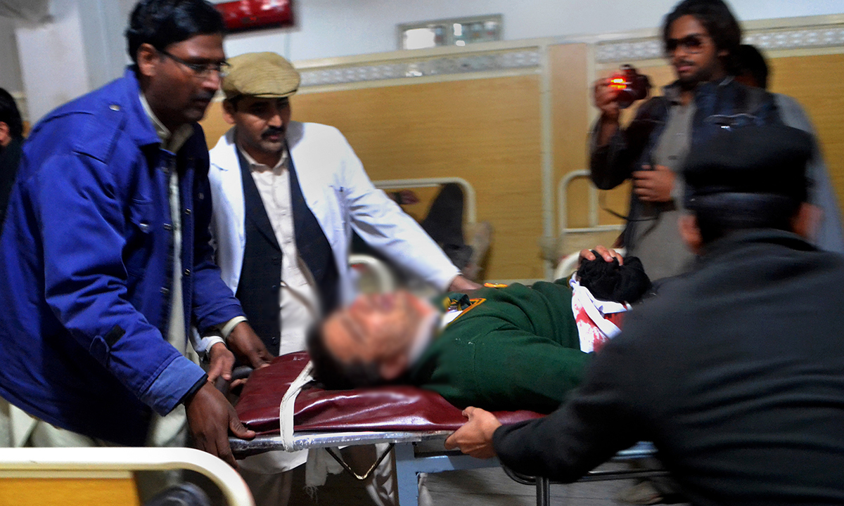 Hospital staff transport an injured student. — AP