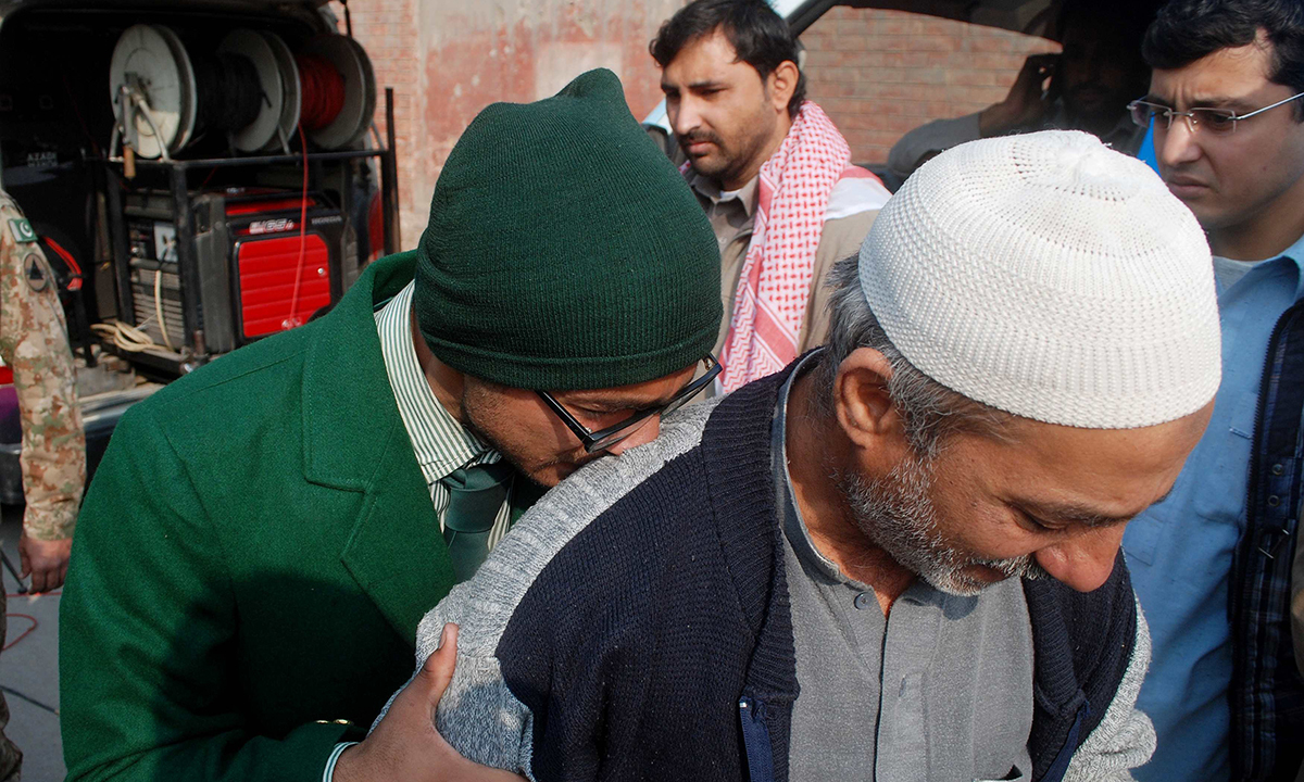 A student cries on a man's shoulder, after he was rescued from the Army Public School.— Reuters