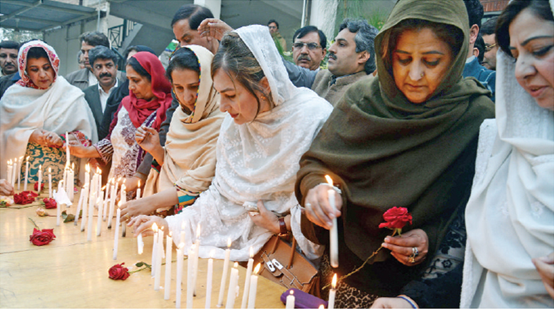 WOMEN leaders of political parties members of civil society hold a candle light vigil in Peshawar. &mdash; White Star