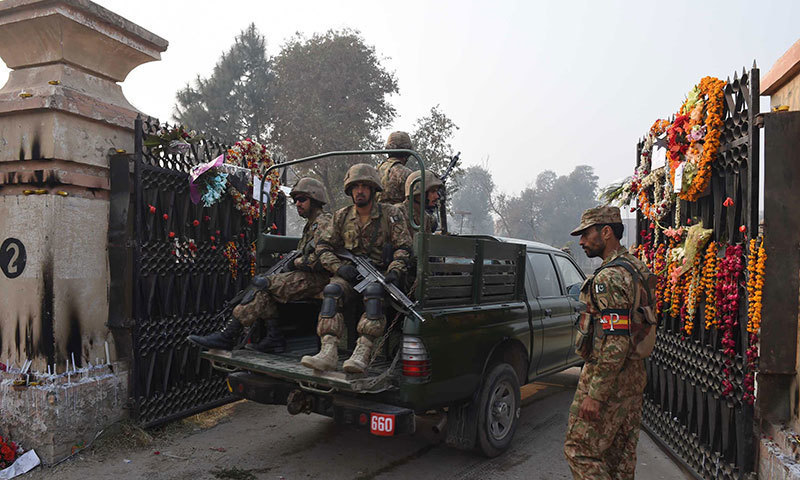 Soldiers enter the Army Public School which was attacked by Taliban militants in Peshawar on December 19, 2014. – AFP