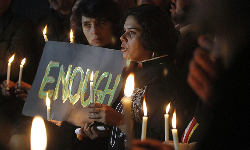 In this photo, civil society members take part in a candle light vigil for the victims of a Peshawar school attacked by the Taliban. &mdash; AP/File