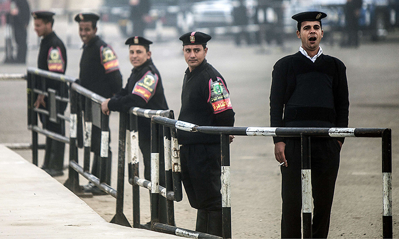 In this photo, Egyptian policemen stand guard outside a Police Academy in Cairo. — AFP/File