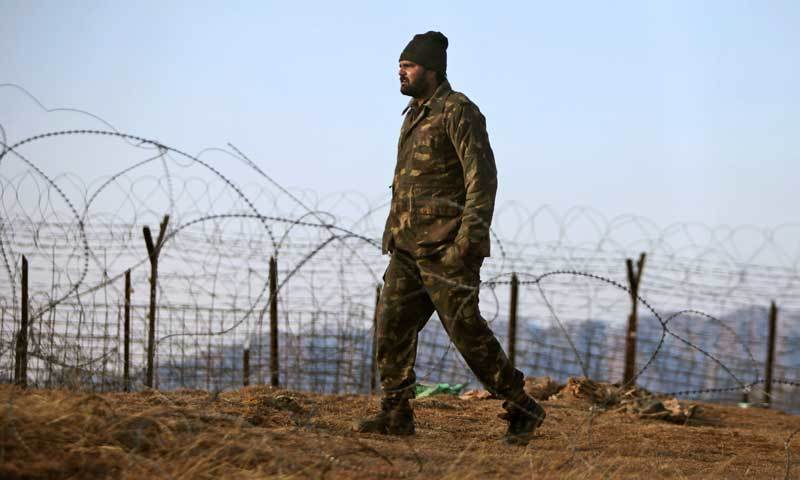 The image shows an Indian soldier patrolling near the border with Pakistan. - AP/File