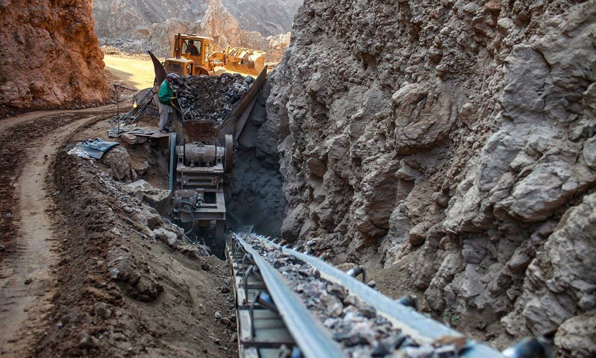 پہاڑوں سے حاصل ہونے  والے خام مال کومشین کے ذریعے چھوٹے ٹکروں میں توڑا جارہا ہے تاکہ مزید باریک کرنے کیلئے دیگر مشینوں کو بھیجا جاسکے  &mdash; فوٹو: رائٹرز