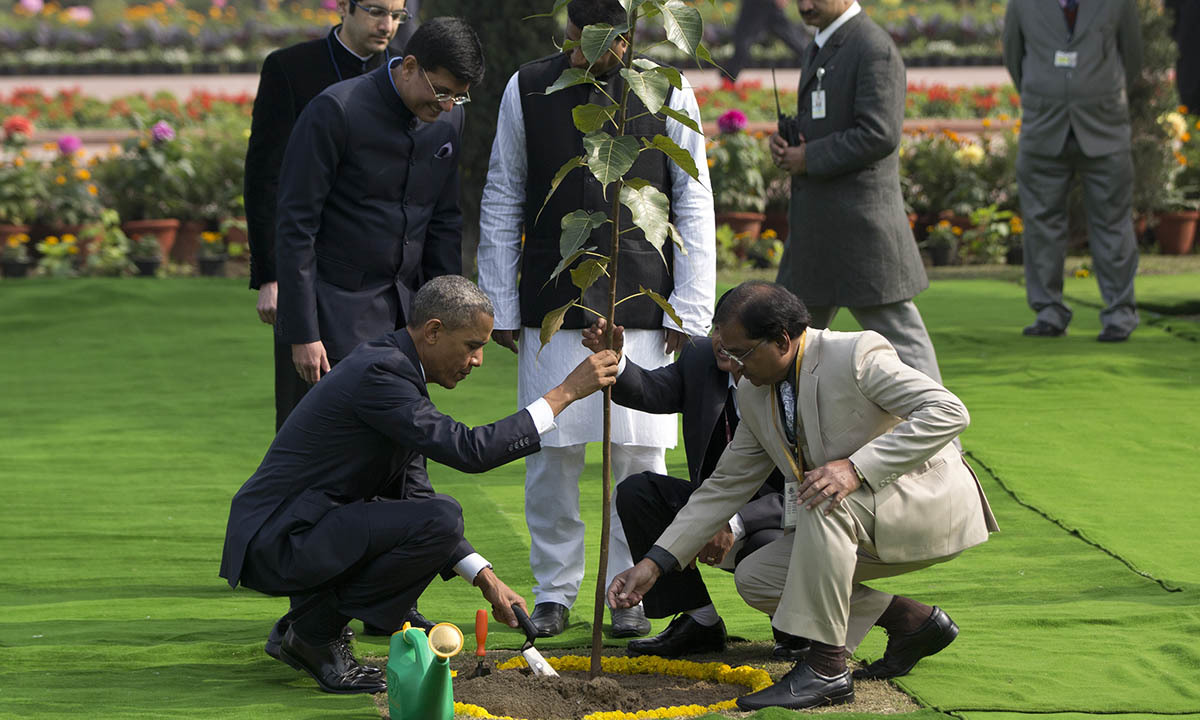 President Barack Obama, left, participates in a tree planting ceremony at the Raj Ghat Mahatma Gandhi Memorial, New Delhi, India, Sunday, Jan. 25, 2015. — AP