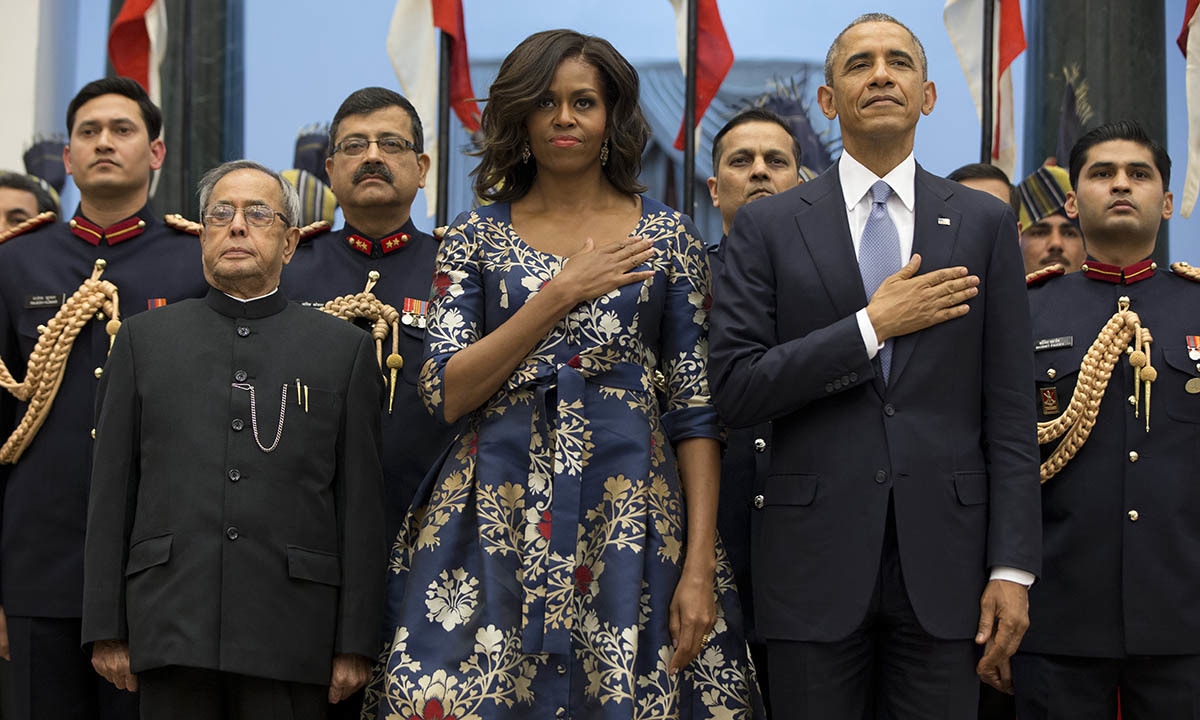 President Barack Obama, right, first lady Michelle Obama and Indian President Pranab Mukherjee, left, stand during the US National Anthem before a receiving line at the State Dinner at the Rashtrapati Bhavan, the presidential palace, in New Delhi, India, Sunday, Jan. 25, 2015. — AP