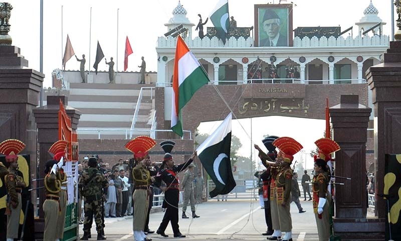 Pakistan Rangers (in black uniform) and Indian Border Security Force personnel (in khaki) perform the flag off ceremony during India's 66th Republic Day at the India-Pakistan Wagah Border Post on January 26, 2015. &mdash; AFP