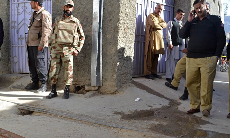 Security officials gather at the site where a policeman, providing security to a polio vaccination team, was killed by gunmen on the outskirts of Quetta. -AFP Photo