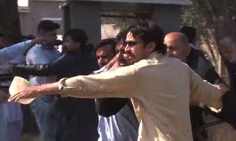 DawnNews screenshot shows rescue workers carrying out injured worshippers. — DawnNews screengrab