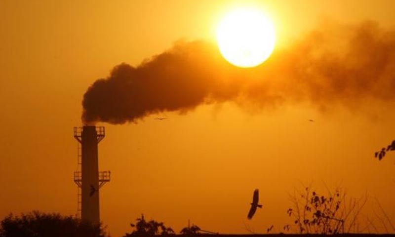 Smoke rises from a chimney in India.  — Reuters