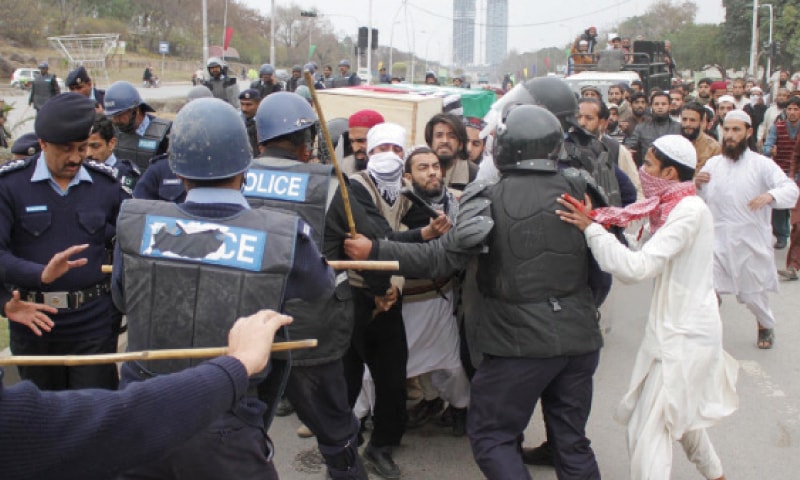 ASWJ activists and Islamabad police personnel scuffle on Constitution Avenue on Sunday. — INP