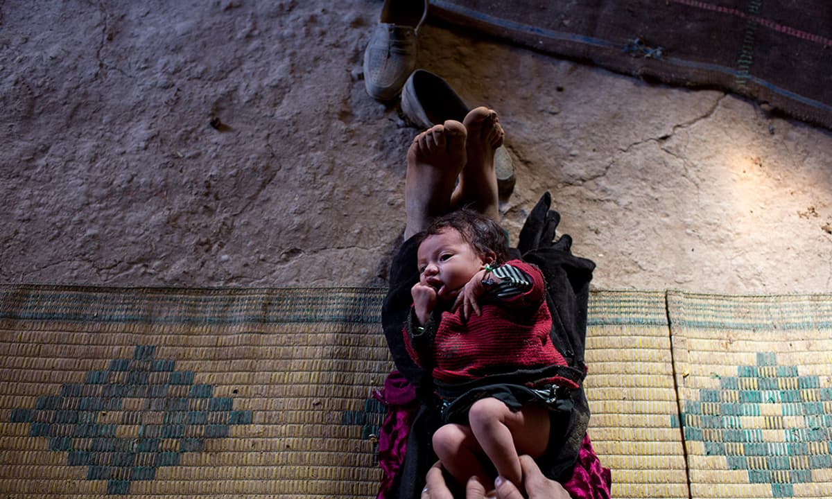 Bari Moumouch plays with her baby in the village of Ait Sghir.