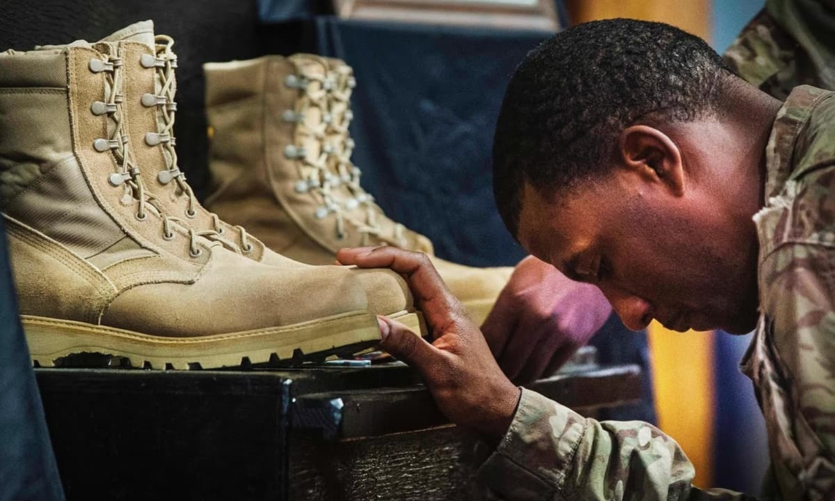 A US soldier pays his respects during a memorial for Martin and Morris.