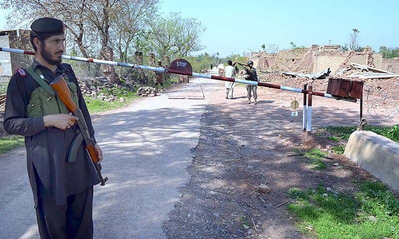 Khasadar force personnel standing alert on a check post in Khyber tribal region's Aka Khel area.— APP