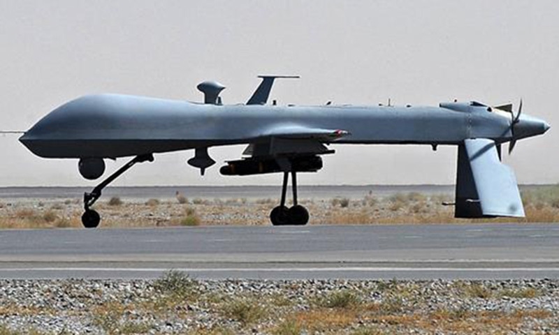 A US Predator unmanned drone armed with a missile on the tarmac of Kandahar military airport in Afghanistan. - AFP