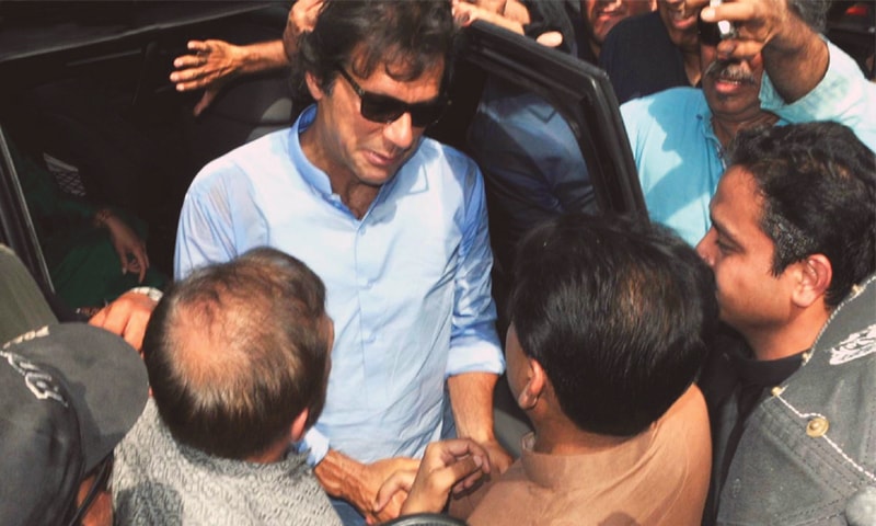 MQM leader Dr Khalid Maqbool Siddiqui welcoms PTI chairman Imran Khan on his arrival at the Jinnah ground.&mdash;Online
